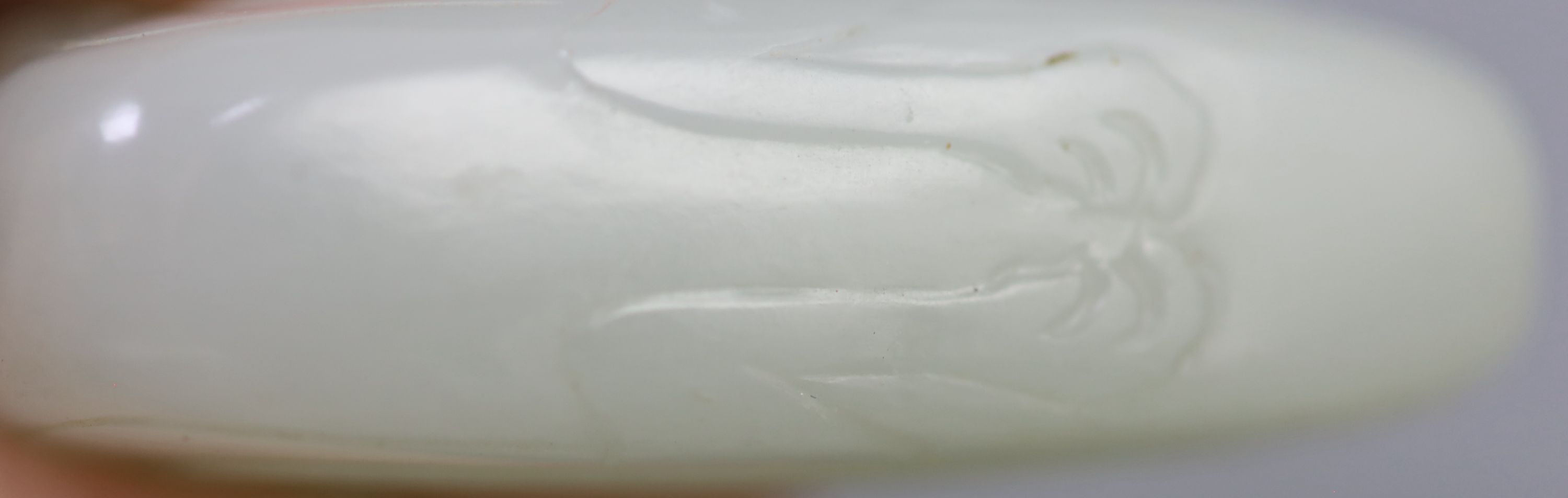 A Chinese archaistic pale celadon jade mandarin duck carving, 19th century, 5cm excluding wood stand